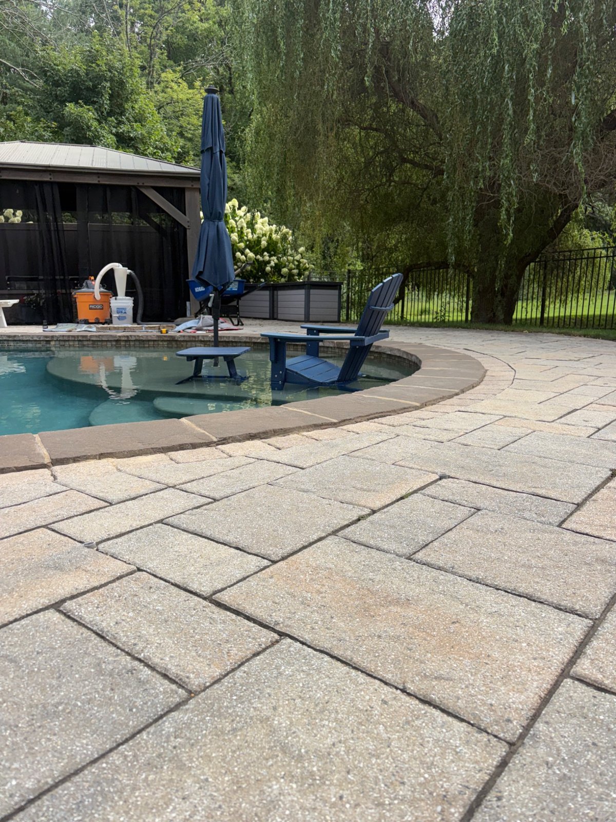 Uneven pavers beside the pool edge