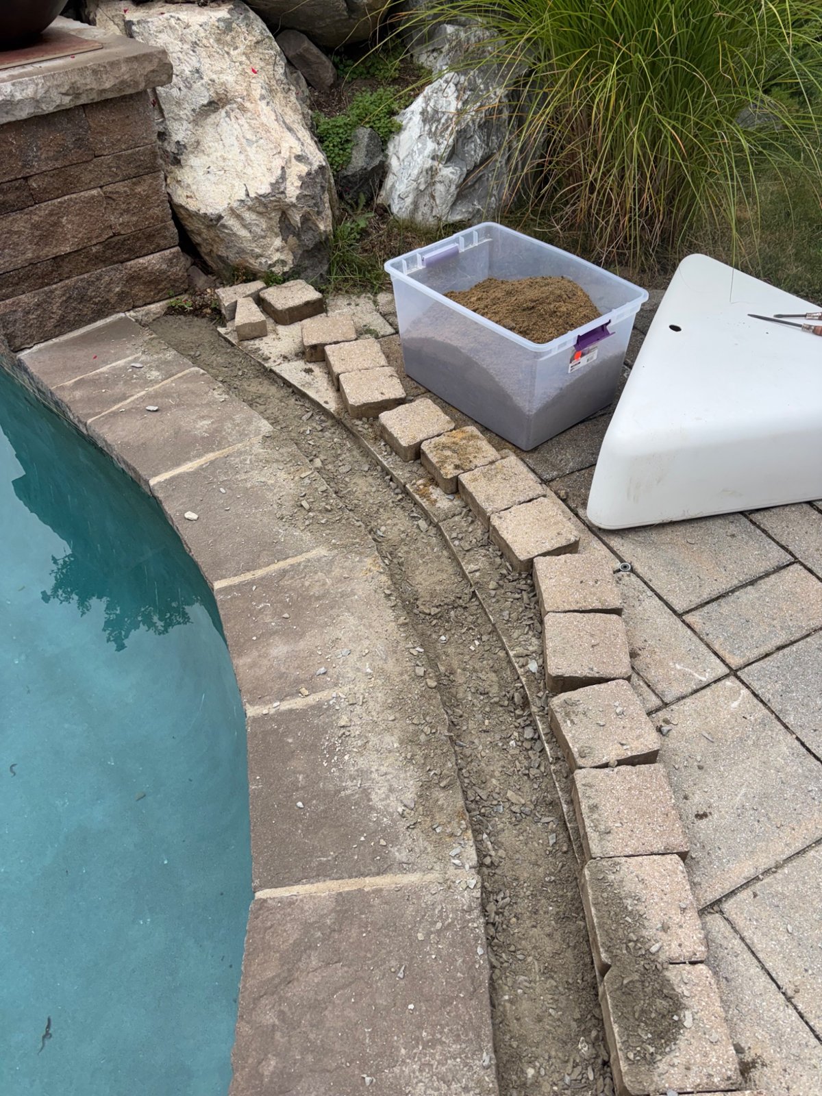 Pavers removed to expose the underlying base